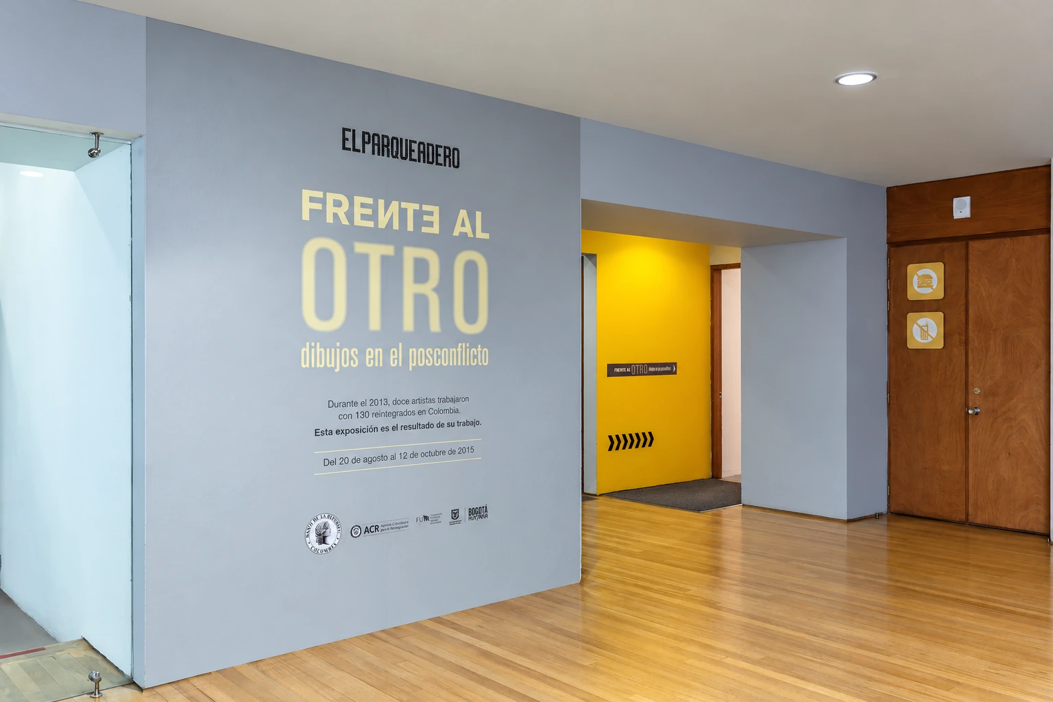 entrance wall with the title — Facing the other